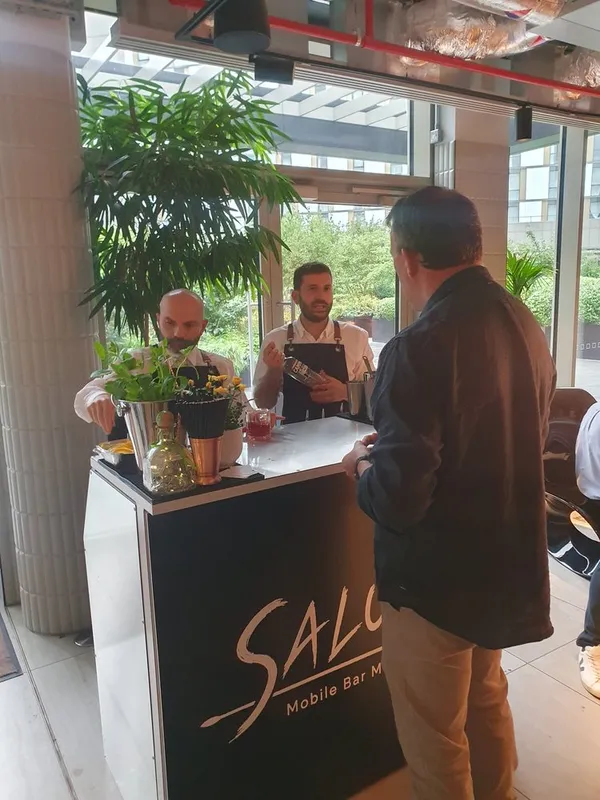 Salute bartenders serving guests at the mobile bar